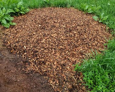A wood chip pile for composting.