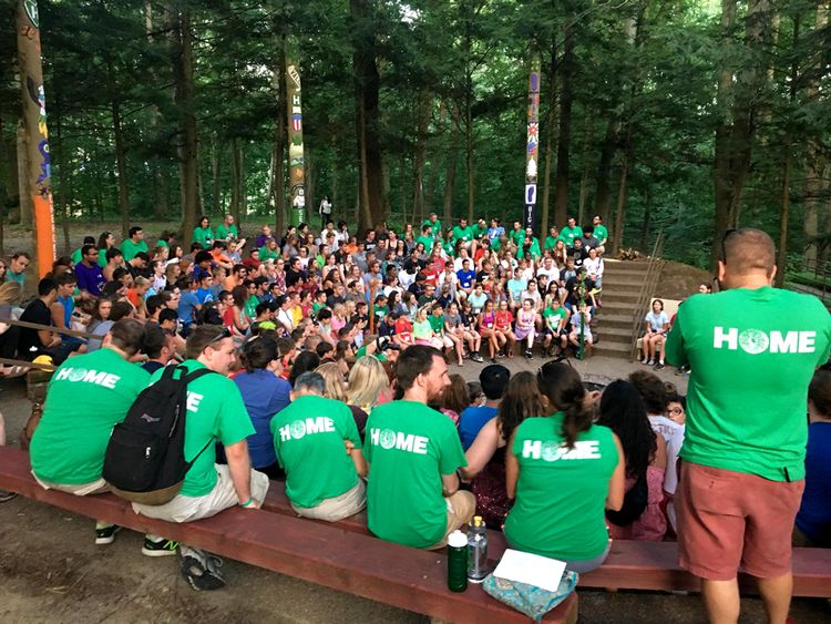 State 4-H Camps; large group of 4-H campers gather for council circle around fire pit
