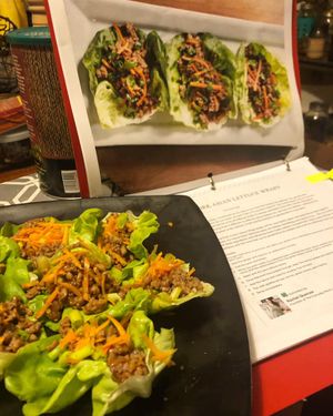 Pork Asian Lettuce Wraps on plate with recipe in background