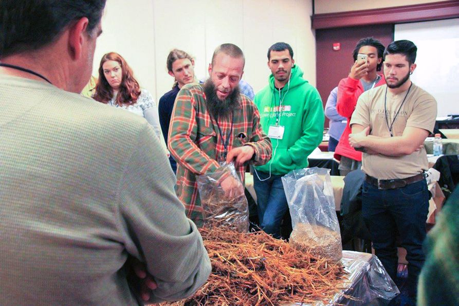 Hands-on learning about mushrooms with instructor and students at previous conference.