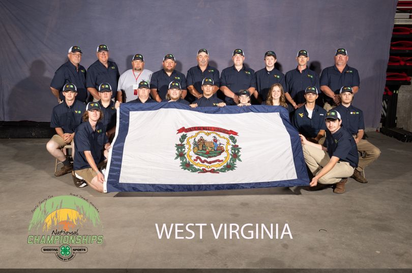 Members of the West Virginia 4-H Shooting Sports team hold the West Virginia State flag for a photo at the 2022 National Shooting Sports Championship.