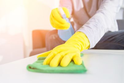 woman cleaning with yellow gloves on