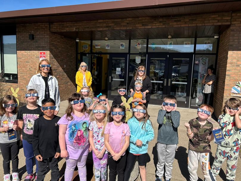 Students and teachers at Allen T. Allison Elementary School in Hancock County smile and pose for a photograph while wearing their WVU Extension STEMCARE eclipse glasses.