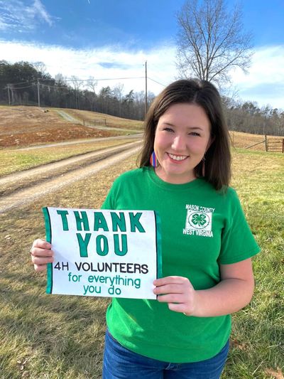 4-H member holding volunteer thank you note