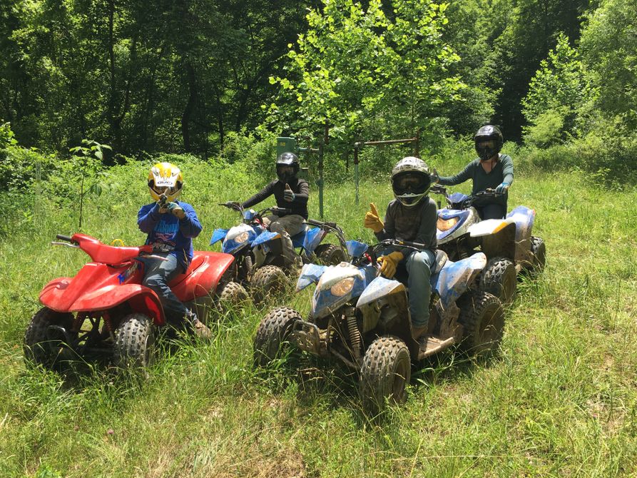 Four youths on ATVs participating in rider safety training. 