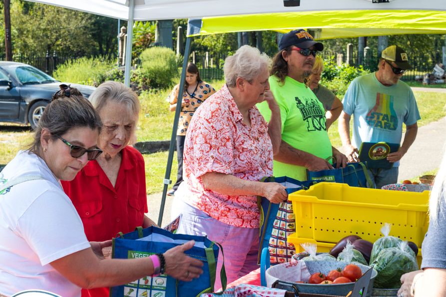 Elderly people getting vegetables at a FARMacy farmers market.