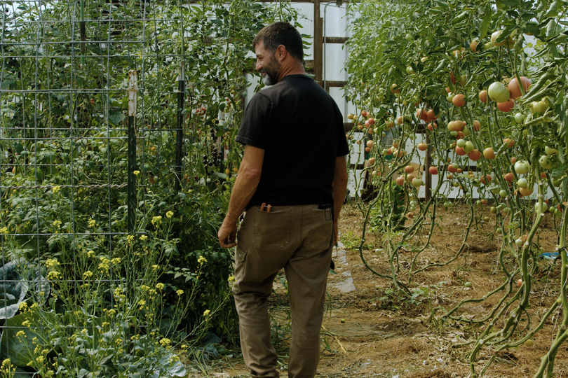 Jerry Brake walks through a greenhouse at his Rt. 18 Farm in Gilmer County, WV.