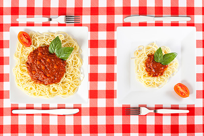 two portions of spaghetti in large and small