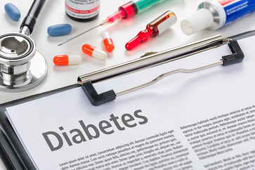 Photo of a paper with information on diabetes surrounded by healthcare tools