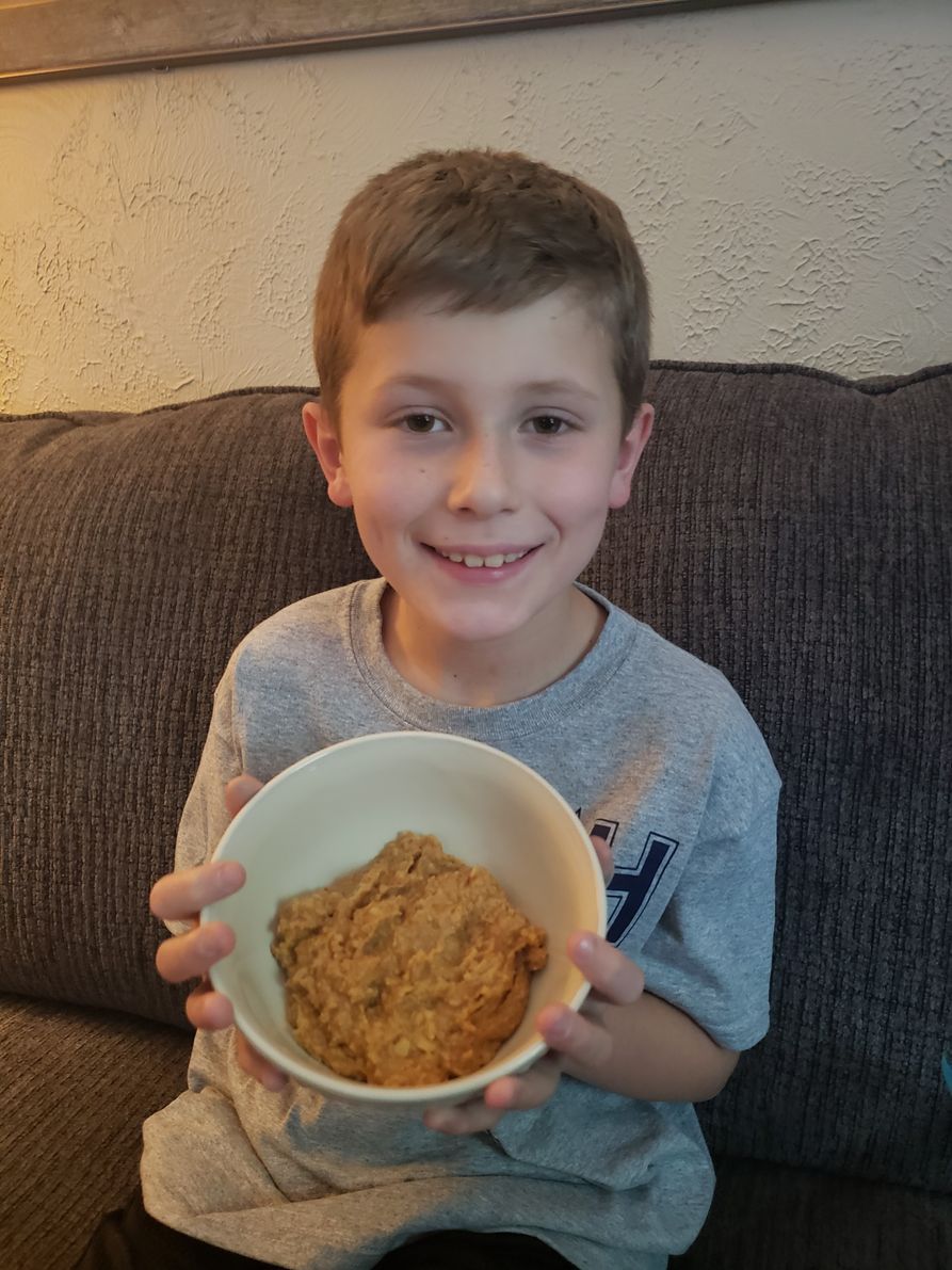 youth holding hummus he made at home