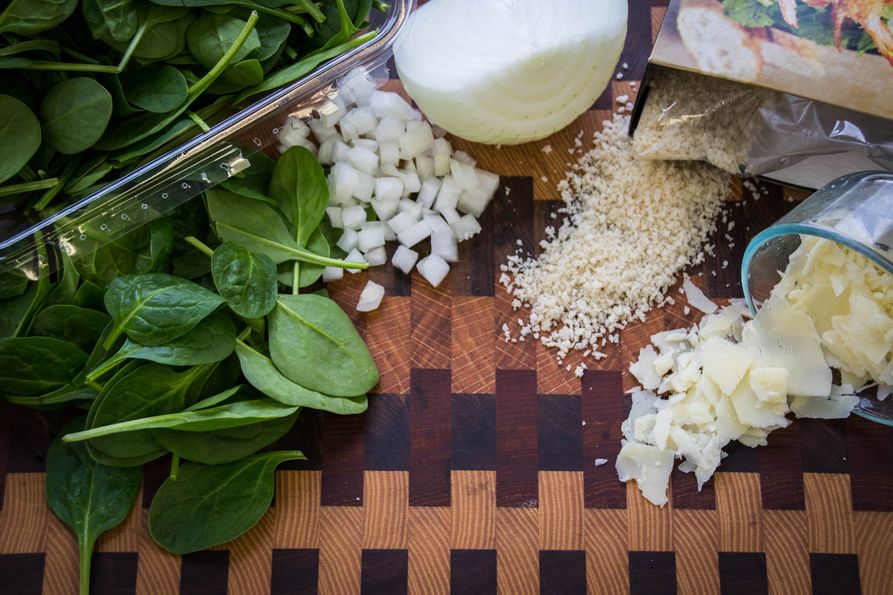 Ingredients for spinach balls on cutting board