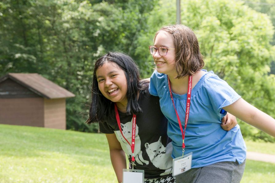 Two friends at 4-H camp smiling and laughing