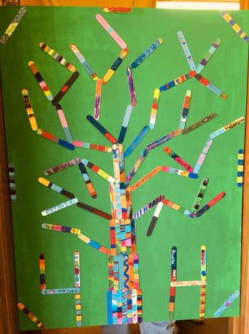 Wayne Co Community Art Project featuring green background and decorated tongue depressor arranged as a tree