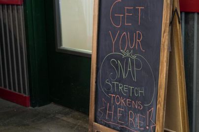 A chalkboard at the Capitol Market in Charleston, W.Va. advertises SNAP Stretch.