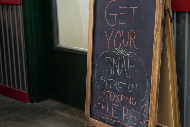 A chalkboard advertising SNAP stretch tokens
