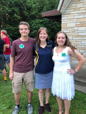 Two 4-H members posing with a 4-H professional after receiving their 4-H Charting Pin