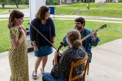 Rory Clark and Becca Fint-Clark interact with Ryan Brandenburg and other musician at WVU Jackson's Mill.