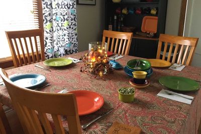 A dinner table set to receive holiday guests.