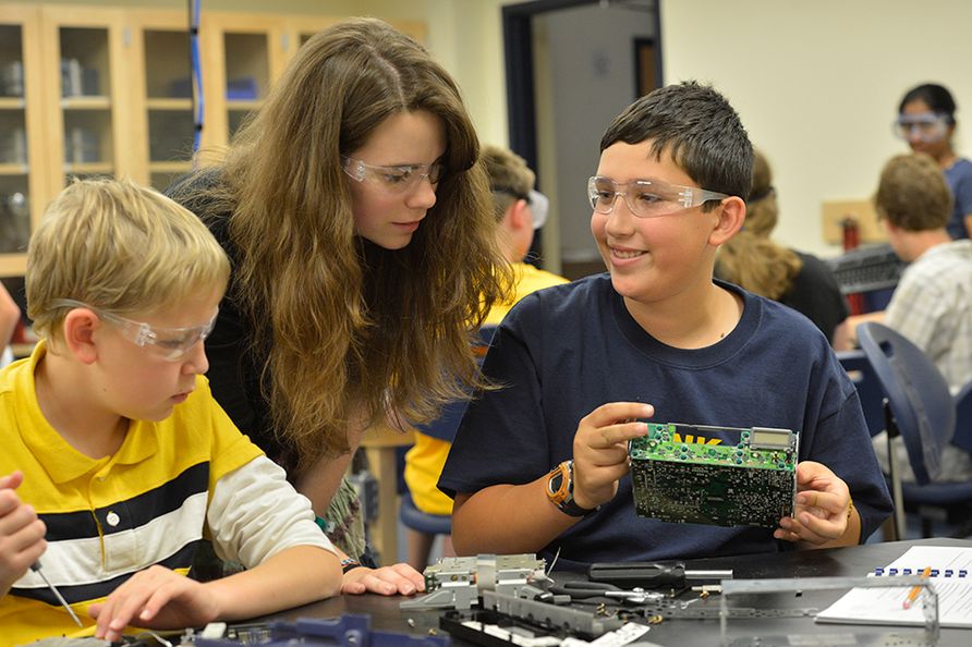 Two students doing a science-related activity at camp.
