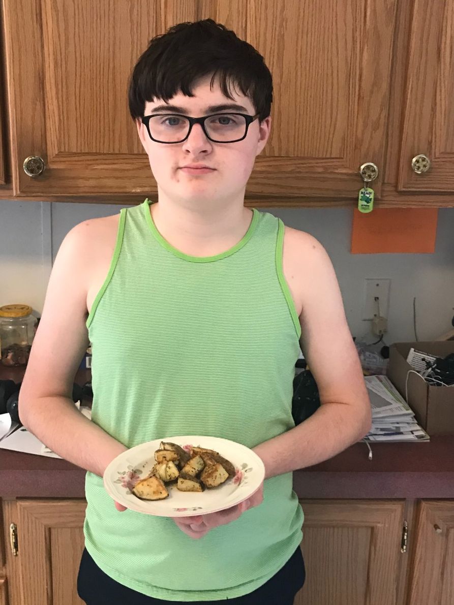 youth with Greek dishes he made