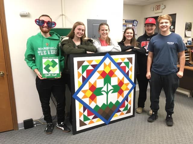 Teens Stand with Completed Quilt Block