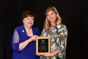 Andi Bennett Hoover (left) received the Distinguished Service Award from the National Extension Association of Family and Consumer Sciences Annual Session