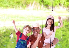 grandpa fishing with grandchildren