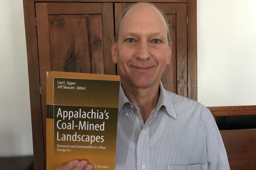 WVU Land Reclamation Specialist Jeff Skousen poses with new book.