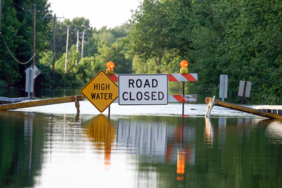 flooded street with road closed signage