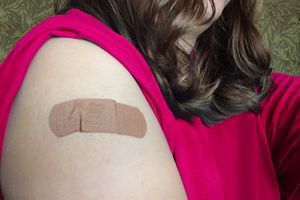 woman's arm with bandaid