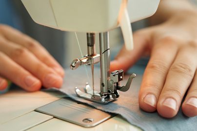 hands using sewing machine