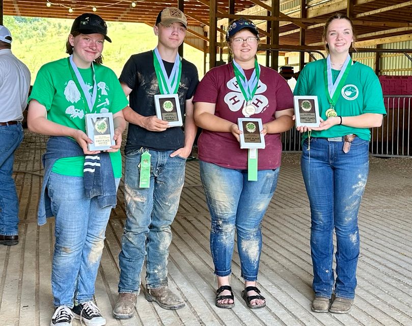Four students pose with their medals and plaques in recognition of winning the WVU Extension senior Land Judging and Homesite contests