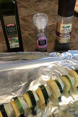 An uncooked veggie kabob sits next to the ingredients.