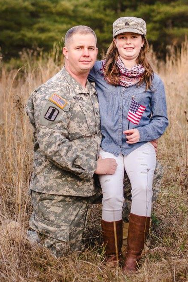 Kymberlyn Morgan, member of Organ Cave 4-H Helpers Club in Greenbrier County, posing with her father Derrick Morgan, Us Army Reserves E6 Staff Sergeant Platoon Sergeant 