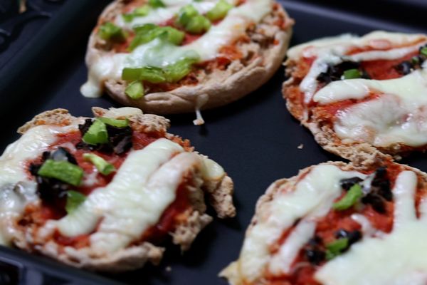 whole grain english muffin pizzas with string cheese, black olives and green peppers