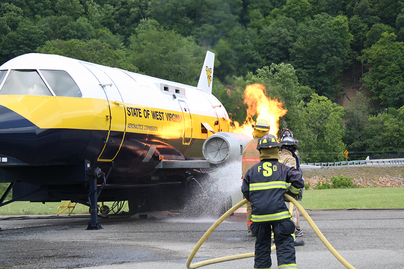firefighters train putting out fire of aircraft