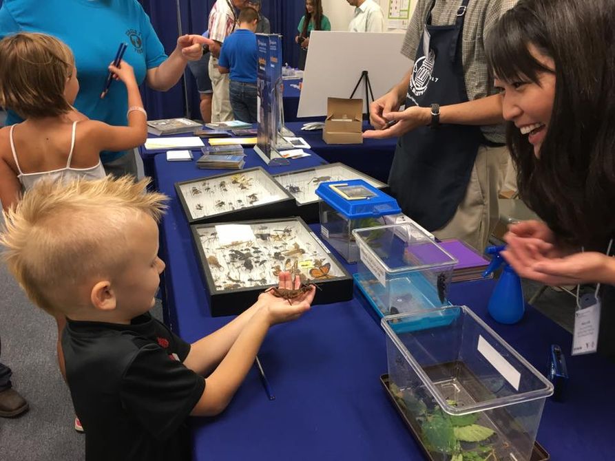 Children interact with exhibitors at WVU Building at State Fair