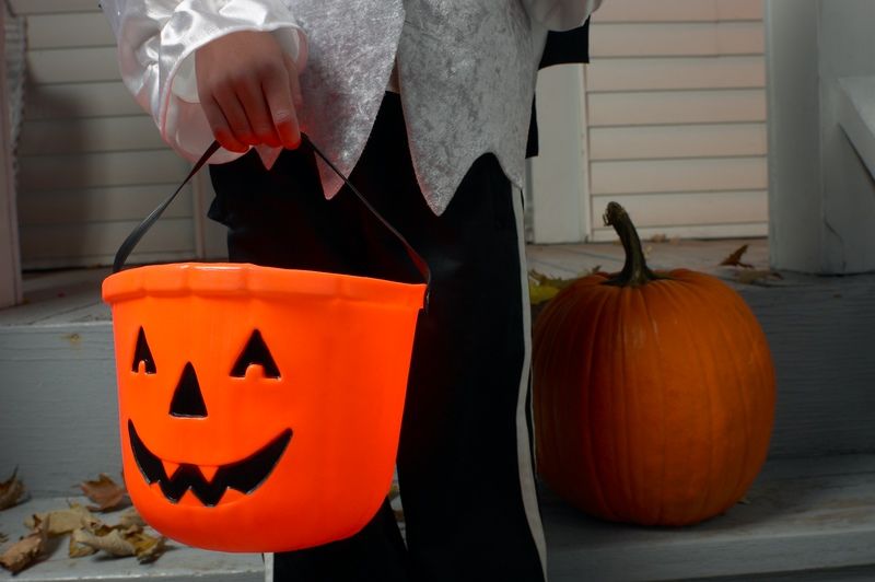 trick or treater with jack-o-lantern pail