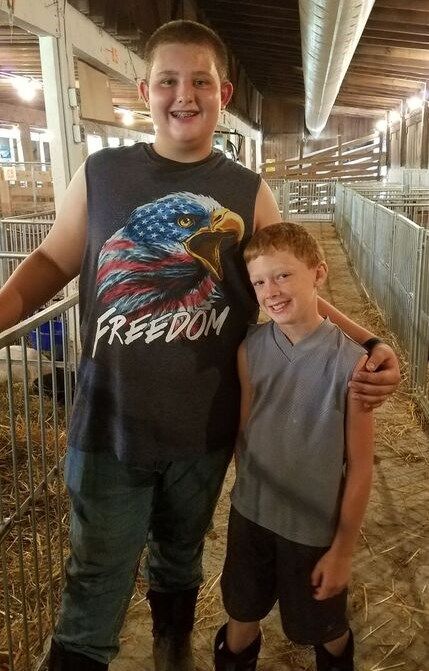 Allen Nestor and Trent Keener take a break and pose for a picture during the Battelle District Fair. 
