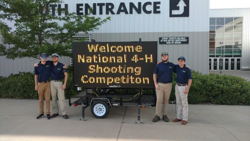 WV 4-H AIr Rifle Team at the National Competition (Billboard says Welcome National 4-H Shooting Competition)