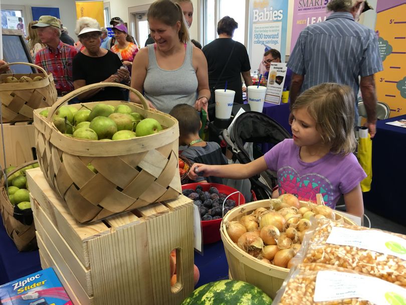 Kids enjoy picking out free fruits and vegetables at the State Fair.