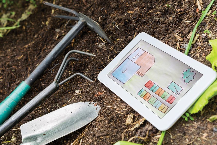 Garden site design with tools and tablet