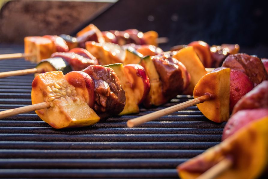 Beef, potato and vegetables on skewer on grill. 