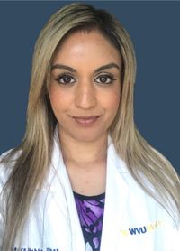 A head and shoulders photo of Meera in a WVU Medicine lab coat