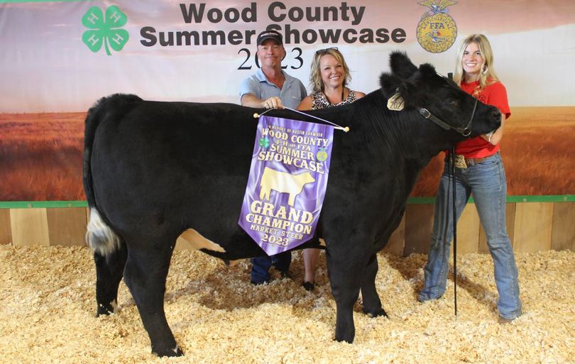 Girl posing with her Champion steer