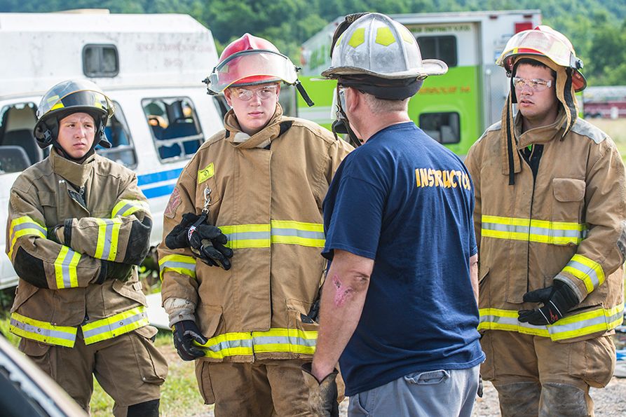 Instructor talks with group of junior firefighters