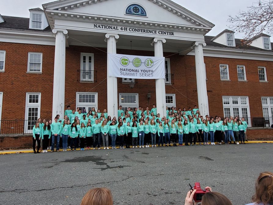 The 200 youth participants of the National Youth Summit stand in front of the National 4-H conference Center for a photo. 
