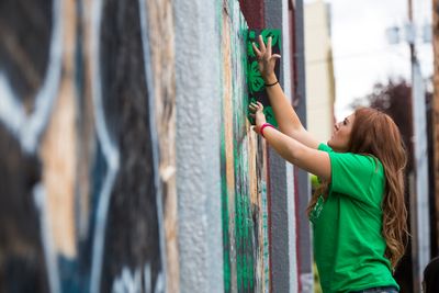 Teenager working on a mural