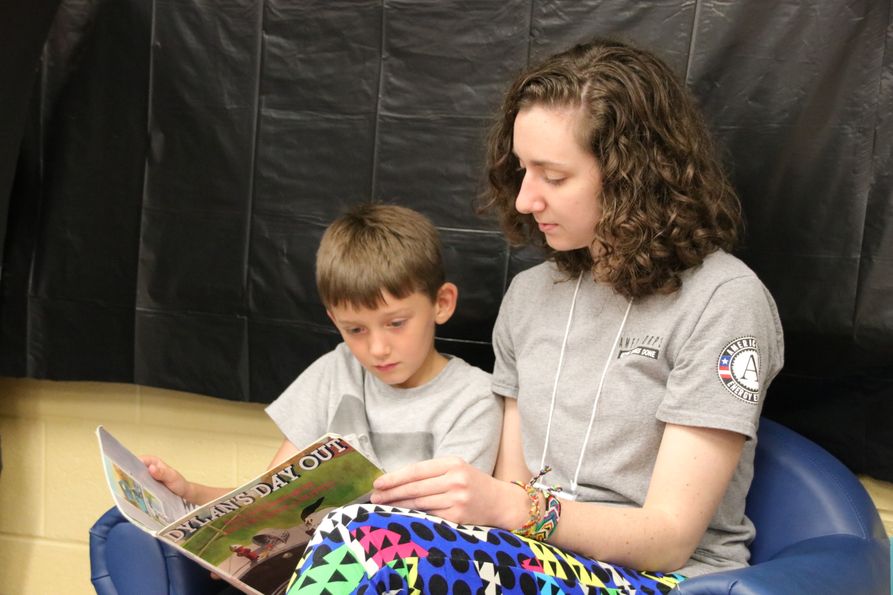 Energy Express mentor reads to young boy.